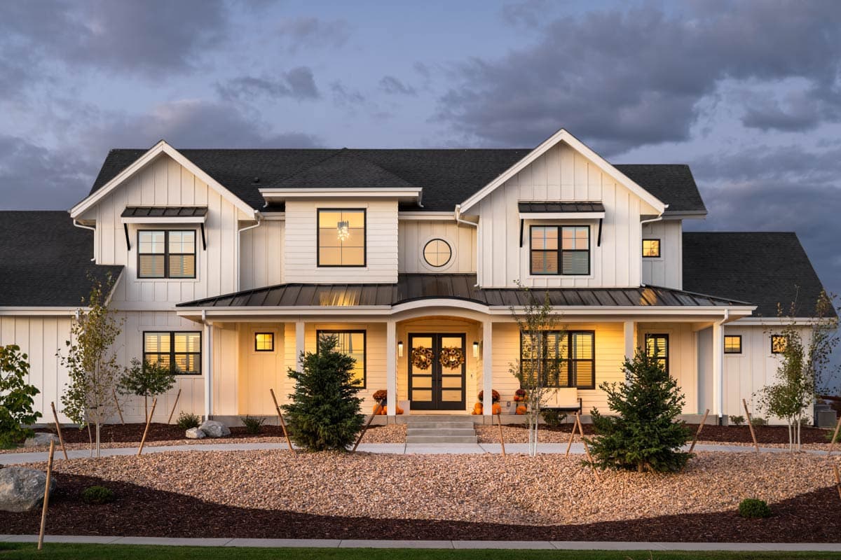 House plan exterior of a two-story Modern Farmhouse with multiple gables, board and batten siding, and a covered front porch with black double doors.