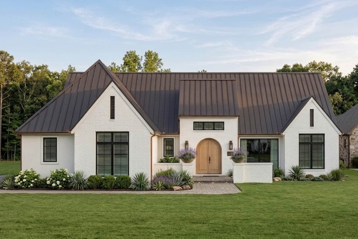 House plan exterior: White brick, single-story Modern Farmhouse with a dark metal roof, gables, and arched wooden double doors.