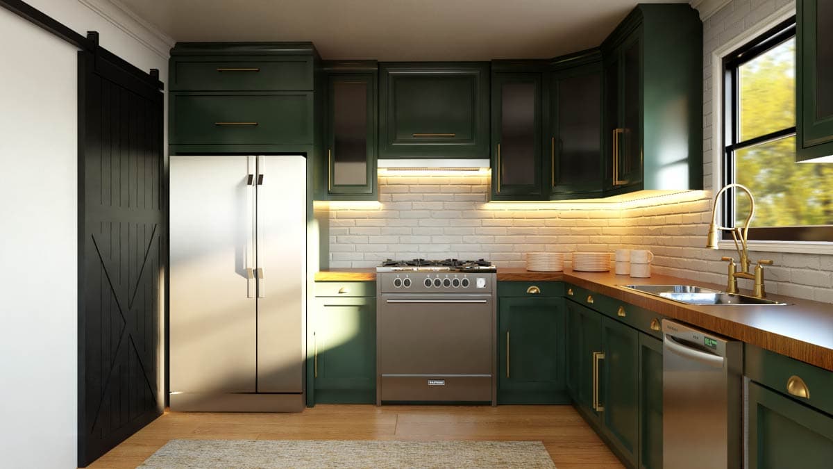 Kitchen with dark green cabinets, stainless steel refrigerator, gas range, white brick backsplash, and sliding barn door.