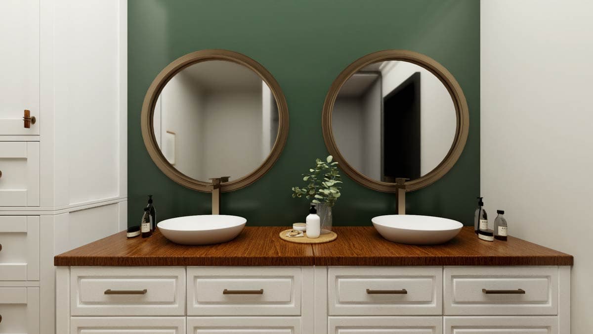 Bathroom vanity with two vessel sinks, round mirrors, wooden countertop, and white cabinetry.