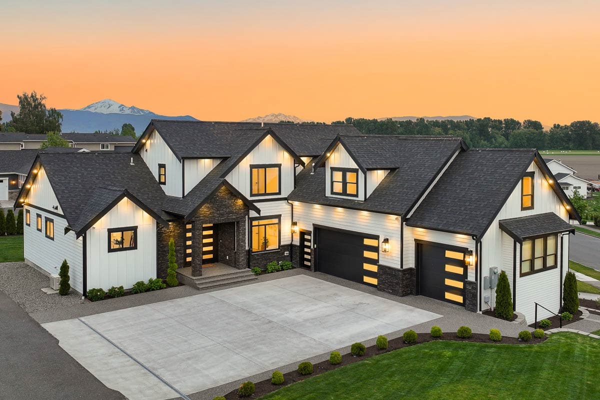 Modern Farmhouse house plan exterior with multiple gables, stone accents, and a three-car garage.