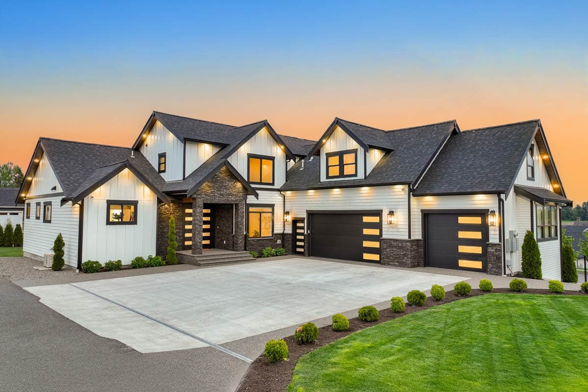 House plan exterior featuring Modern Farmhouse style with a two-story design, multiple gables, and a three-car garage.