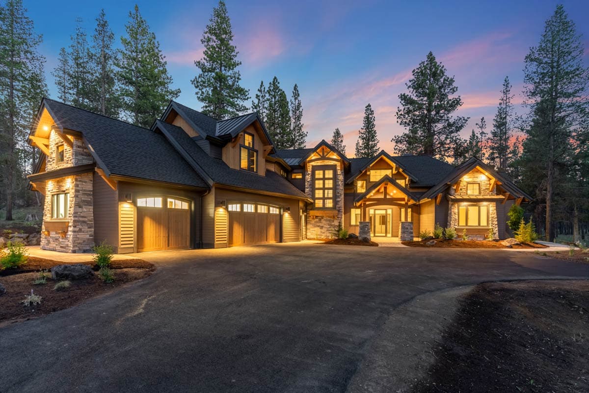 House plan exterior shows a multi-story home with stone accents, multiple gables, and a triple garage.