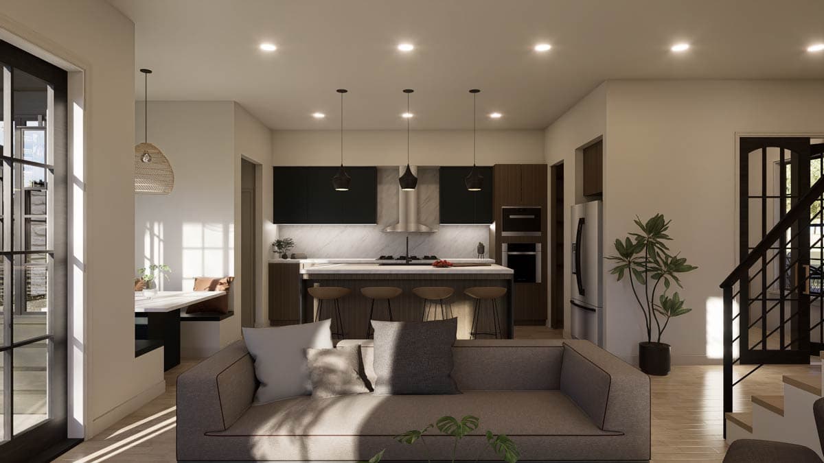 Modern kitchen with island, breakfast bar, and open living space featuring a sectional sofa and dining nook.