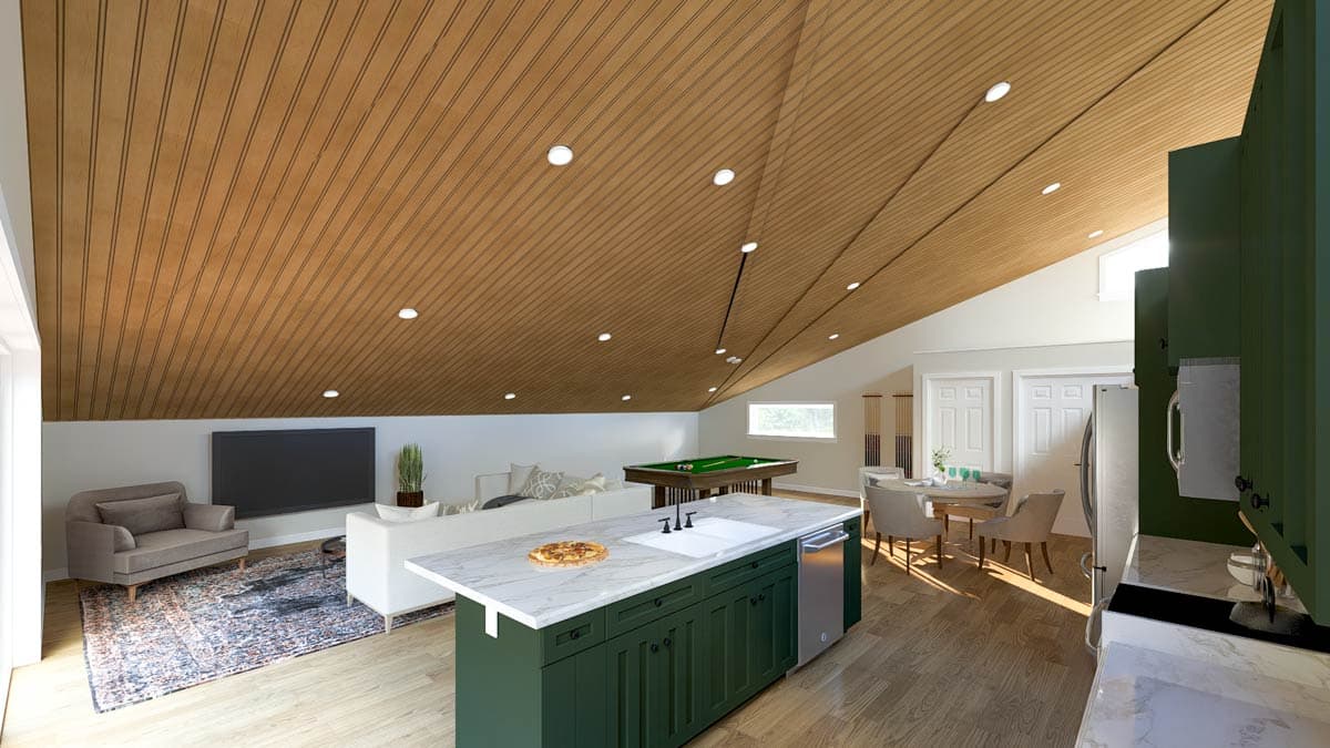 Open-concept interior with sloped wood-paneled ceiling, kitchen island, dining area, and living space with pool table.