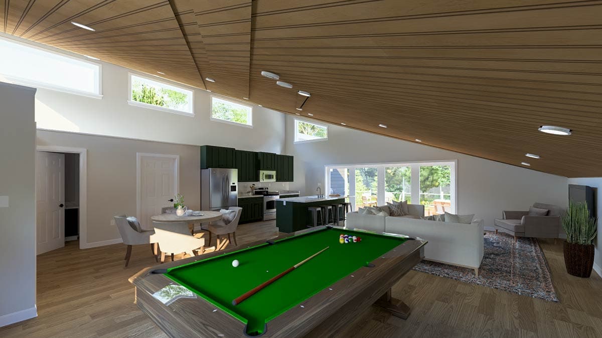 Open-concept living area with a pool table, kitchen island, dining table, and seating area under a sloped wood-paneled ceiling.