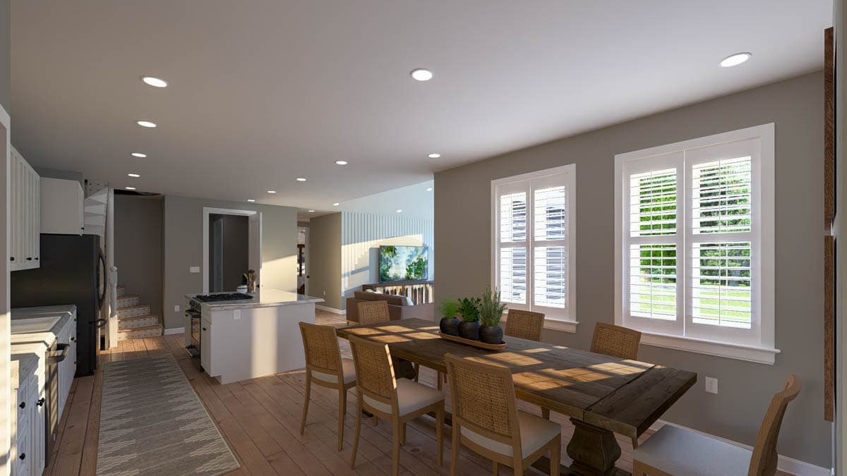 Open concept dining and kitchen area with island, spiral staircase, and large shuttered windows.