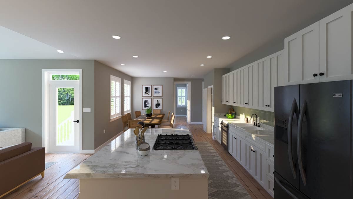 Modern kitchen with large island cooktop, white shaker cabinets, subway tile backsplash, and stainless steel refrigerator.