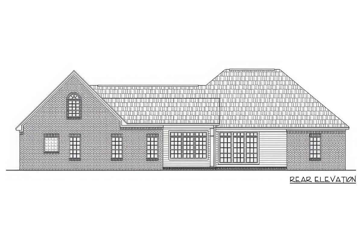 Rear elevation of a house plan featuring a brick facade, dormer window, large grid windows, and a prominent roofline.