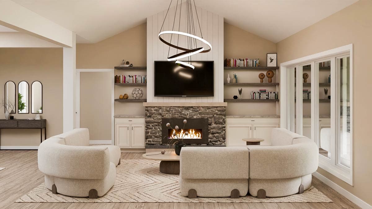 Living room with stone fireplace, television, vaulted ceiling, built-in shelves, and circular sofa.