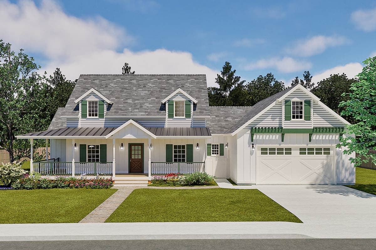 A white farmhouse with green shutters and trim sits on a manicured lawn. A paved walkway leads to the front door under a porch.
