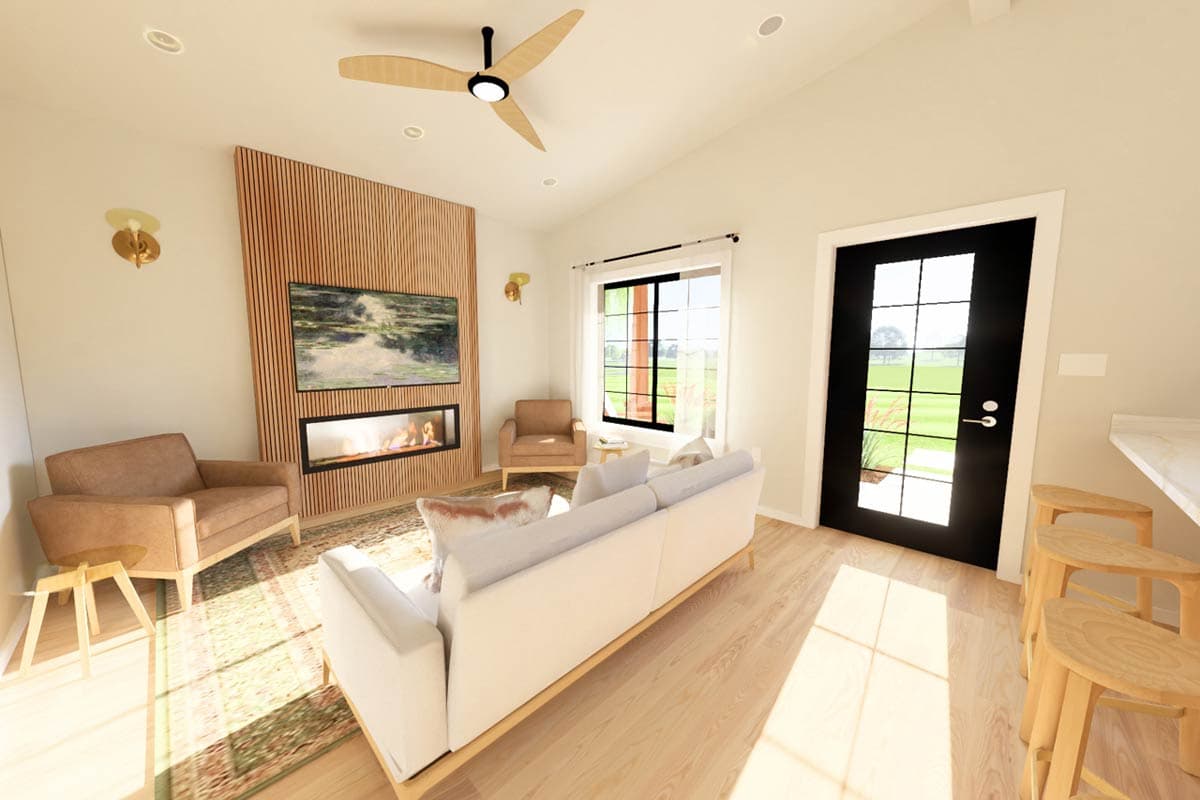 Living area with vaulted ceiling, wood accent wall, fireplace, television, seating, and a door with large glass panes.