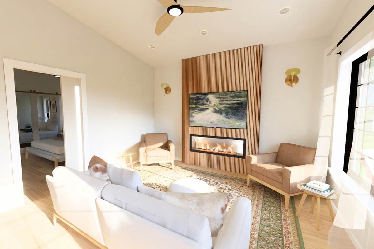 Living room with fireplace, television, seating, ceiling fan, and doorway to bedroom.