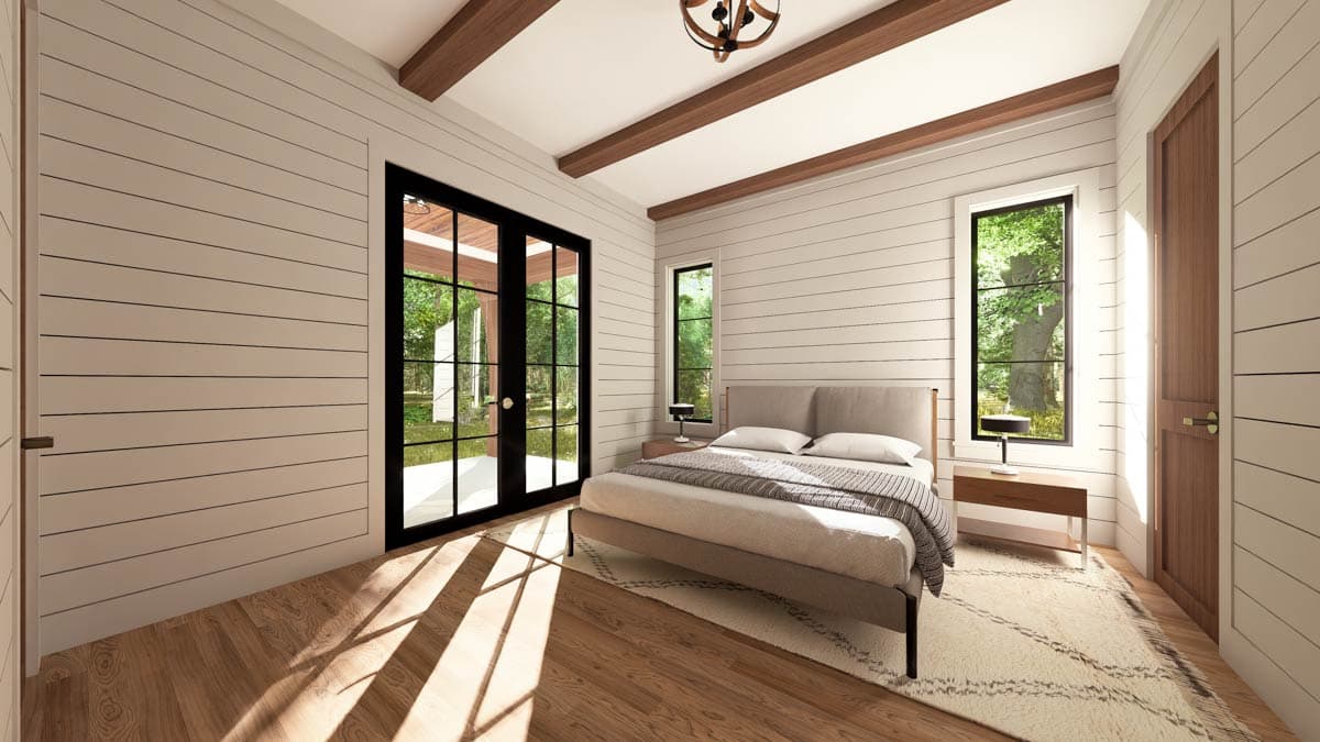 Bedroom with shiplap walls, wood beams on ceiling, double glass doors, and two tall windows.