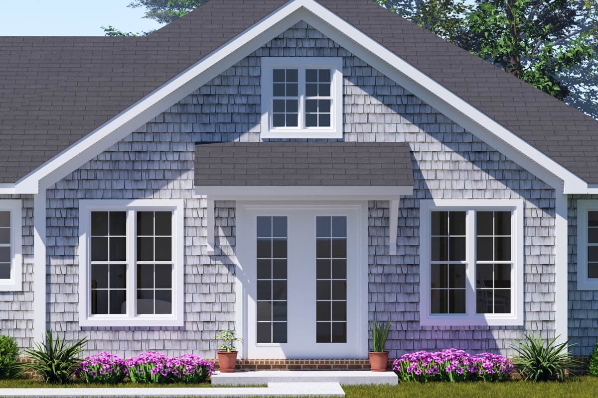 House plan exterior: clapboard siding, dual-pane windows, arched gable dormer, and covered double-door entry.