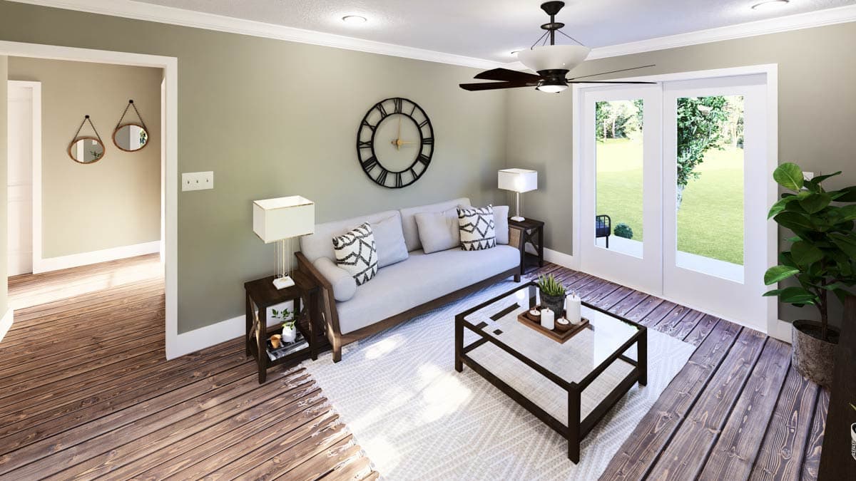 Cozy living room with a sofa, glass coffee table, and large clock. The room features a rug and doors leading to an outdoor view.