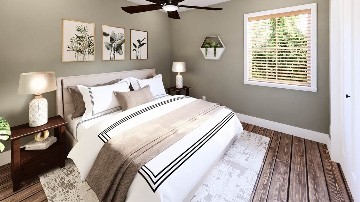 A modern bedroom with a bed featuring a white comforter and black trim. Decorative art hangs above, and a window with blinds provides natural light.