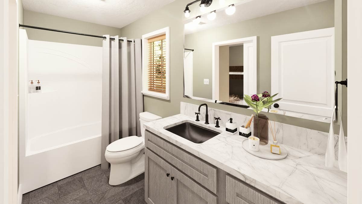 A modern bathroom features a gray vanity with a marble countertop, black fixtures, and a white tub with a gray curtain. A window offers natural light.