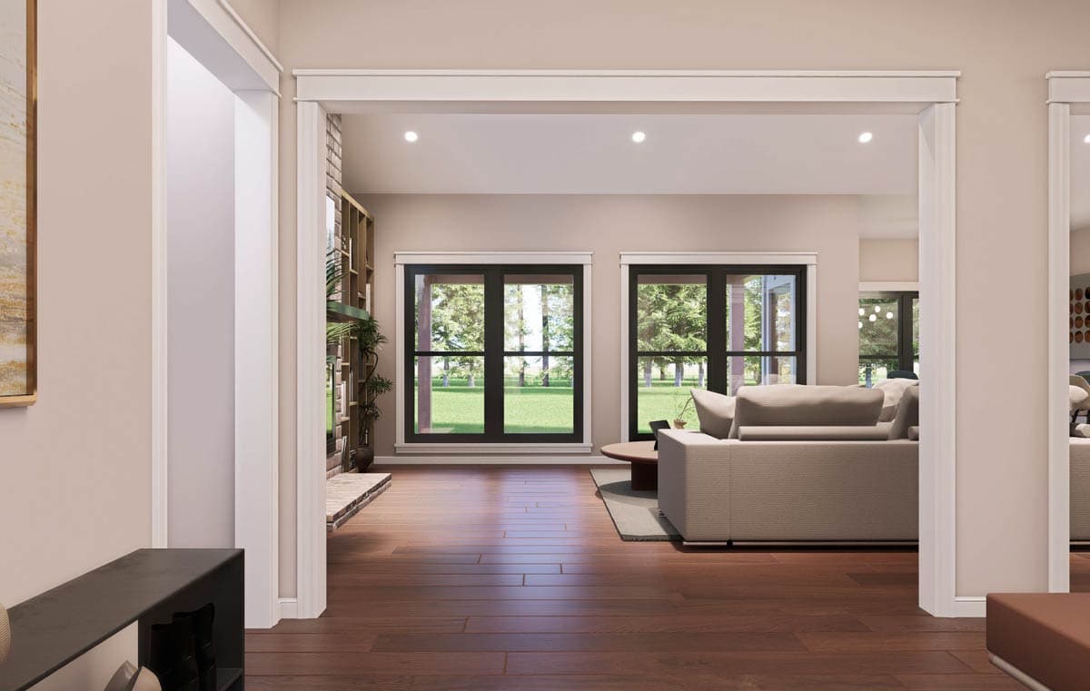 Living room with large windows, fireplace, built-in shelving, and hardwood floors.