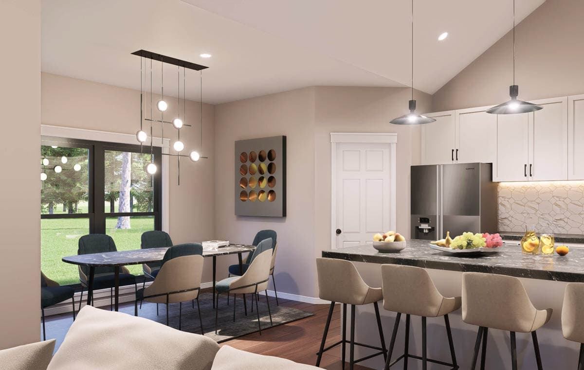 Open concept dining area with large windows adjacent to a kitchen with island, bar seating, and stainless steel refrigerator.