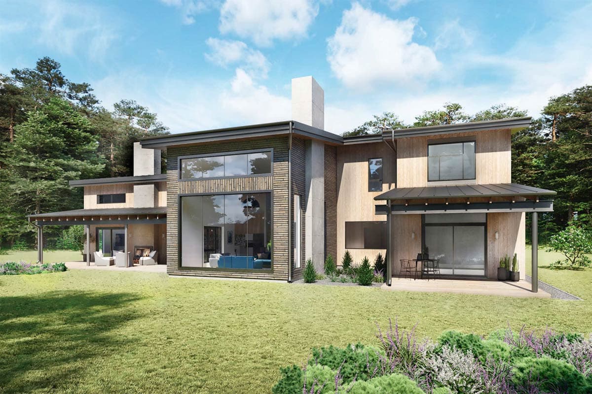 Modern house with wood siding and large windows, surrounded by green lawn and trees. Features a porch and outdoor seating area.