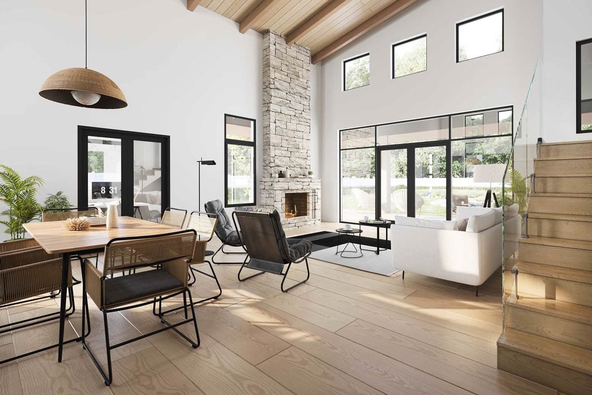 Modern living room with fireplace, dining table, and large windows. Features vaulted ceilings and clerestory windows.