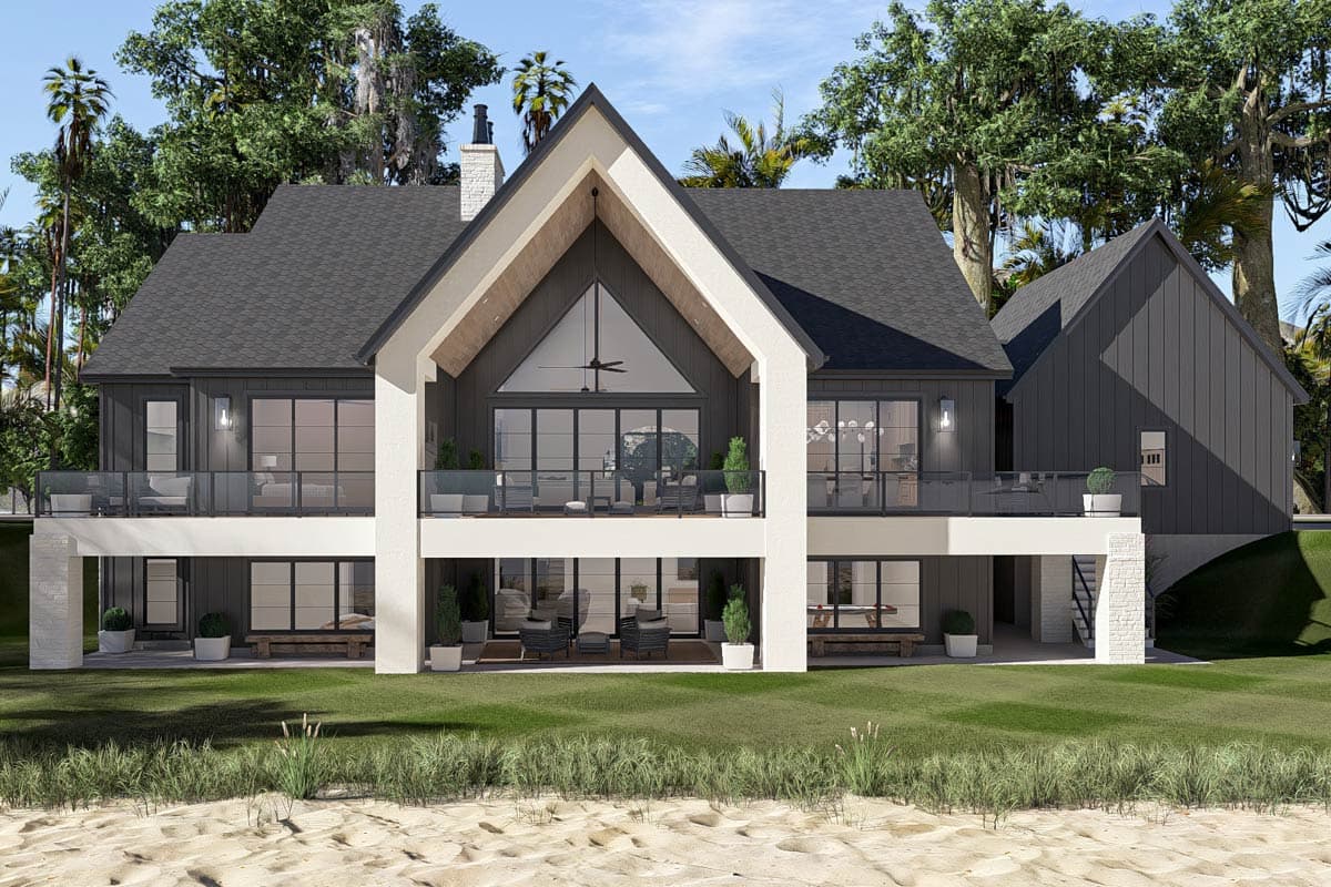 House plan exterior: Modern farmhouse style with two stories, large gables, a prominent peaked roof, and wrap-around balconies.