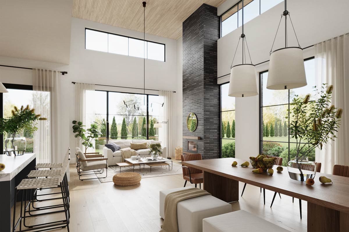 Open concept living space with vaulted ceilings, large windows, and a floor-to-ceiling brick fireplace.