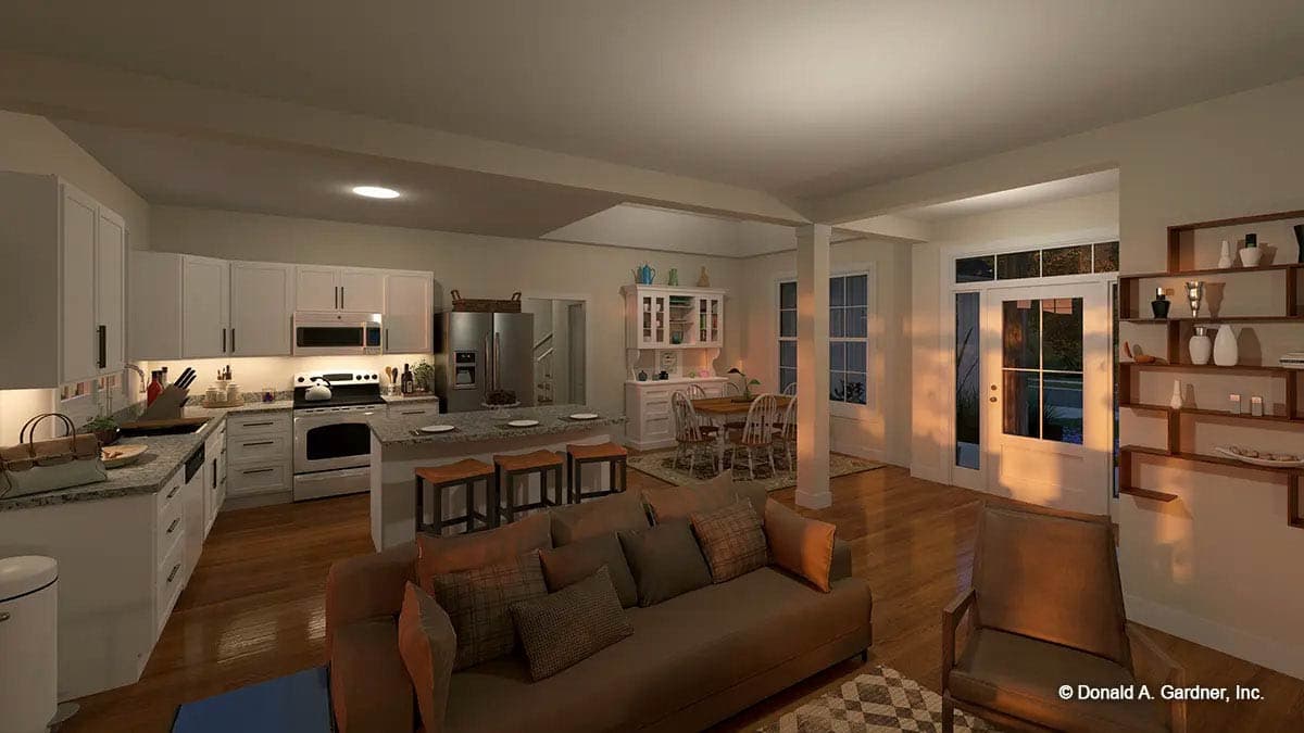 Open concept interior showing kitchen with island, dining area, and living room with fireplace and large windows.