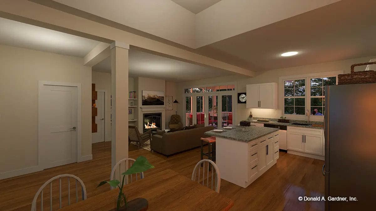 Open concept living area with fireplace, kitchen island, dining table, and doors leading to a covered porch.