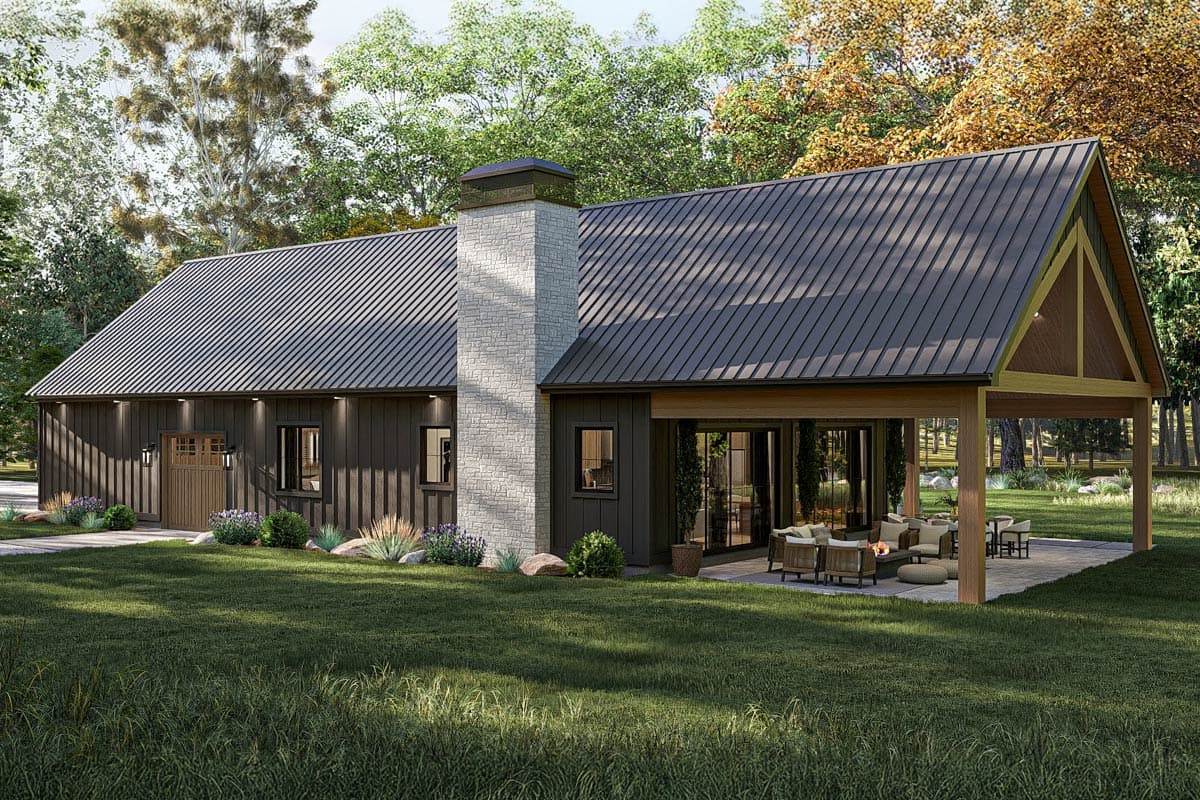 Modern Farmhouse house plan exterior with metal roof, stone chimney, vertical siding, and covered patio with seating.