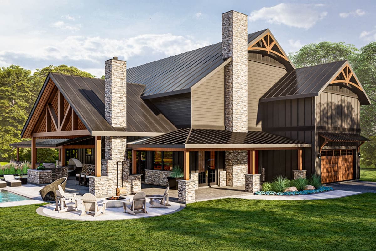 House plan exterior with stone chimneys, exposed gable trusses, covered porch, and a detached garage. Features metal roofing and a stone fireplace.