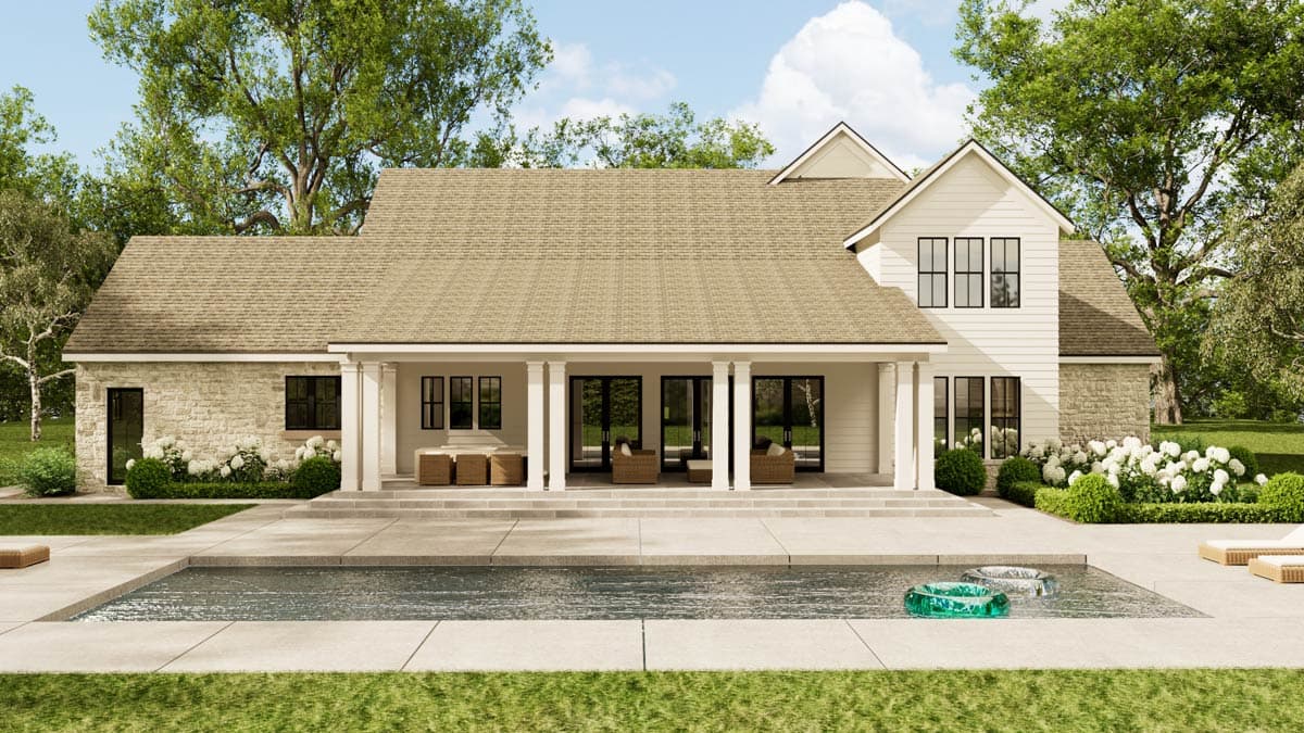 Exterior shot of a modern farmhouse with a pool. The house has a covered porch, stone accents, and a pool with floaties.