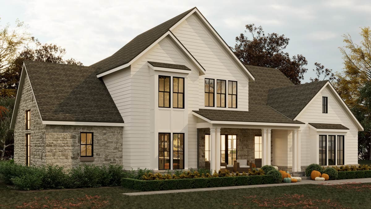 Exterior view of a two-story farmhouse with stone and white siding, featuring large windows and a covered porch.