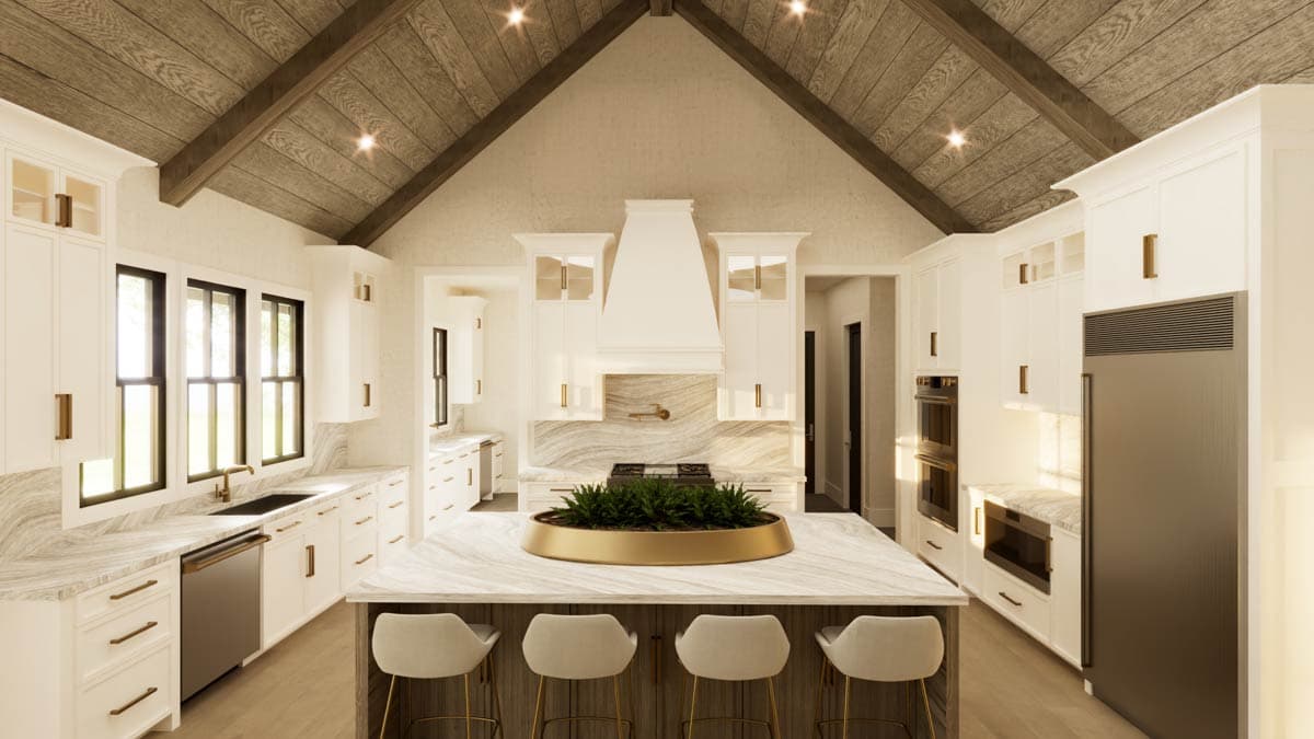 Spacious, modern kitchen with white cabinets, marble countertops, wooden vaulted ceiling and island seating with plants.
