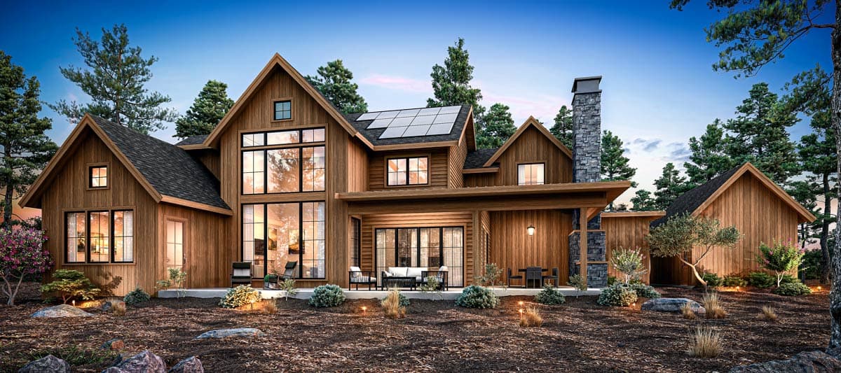 Modern Farmhouse style house plan exterior with gables, stone chimney, solar panels, and large windows.