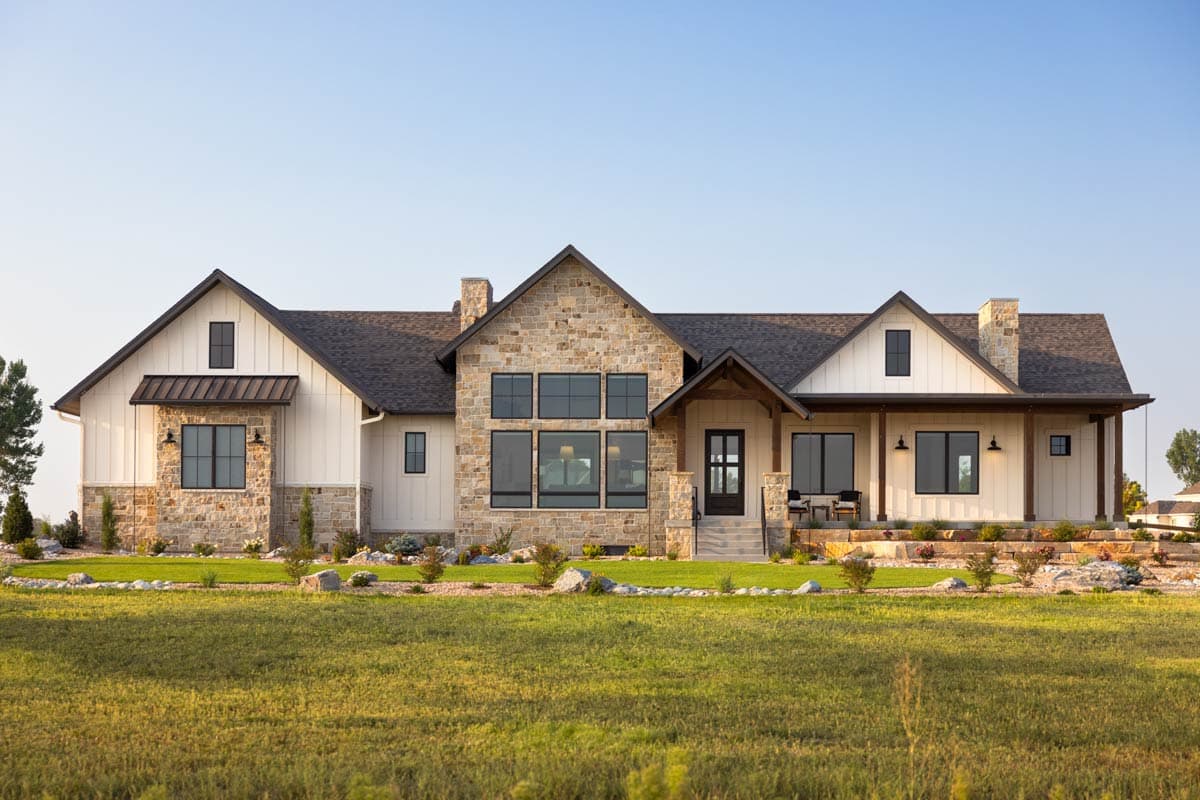 Modern Farmhouse house plan exterior with stone accents, large windows, covered porch, and gabled dormers.