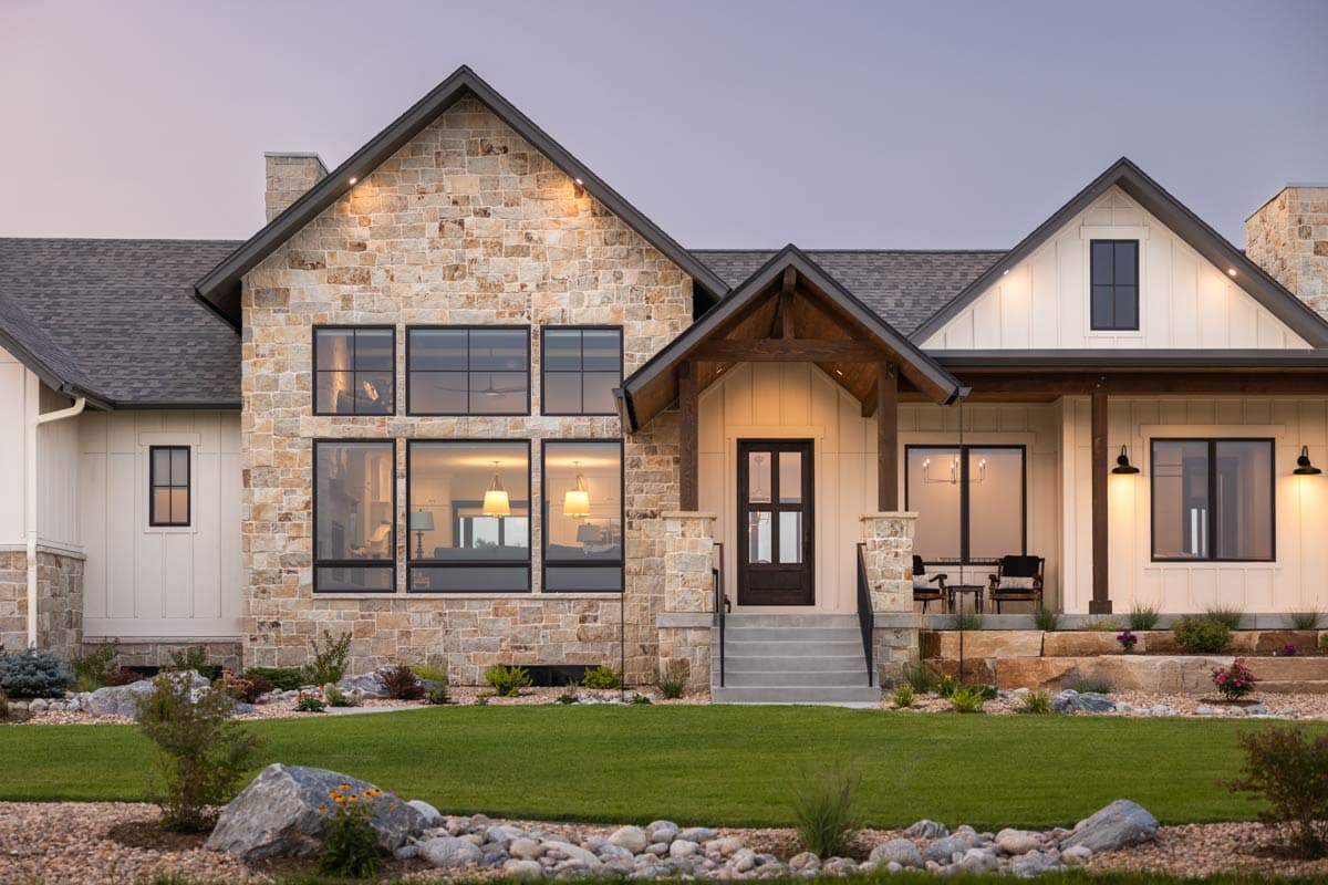 Modern Farmhouse house plan exterior with stone facade, gable roof, covered entry porch, and large windows.