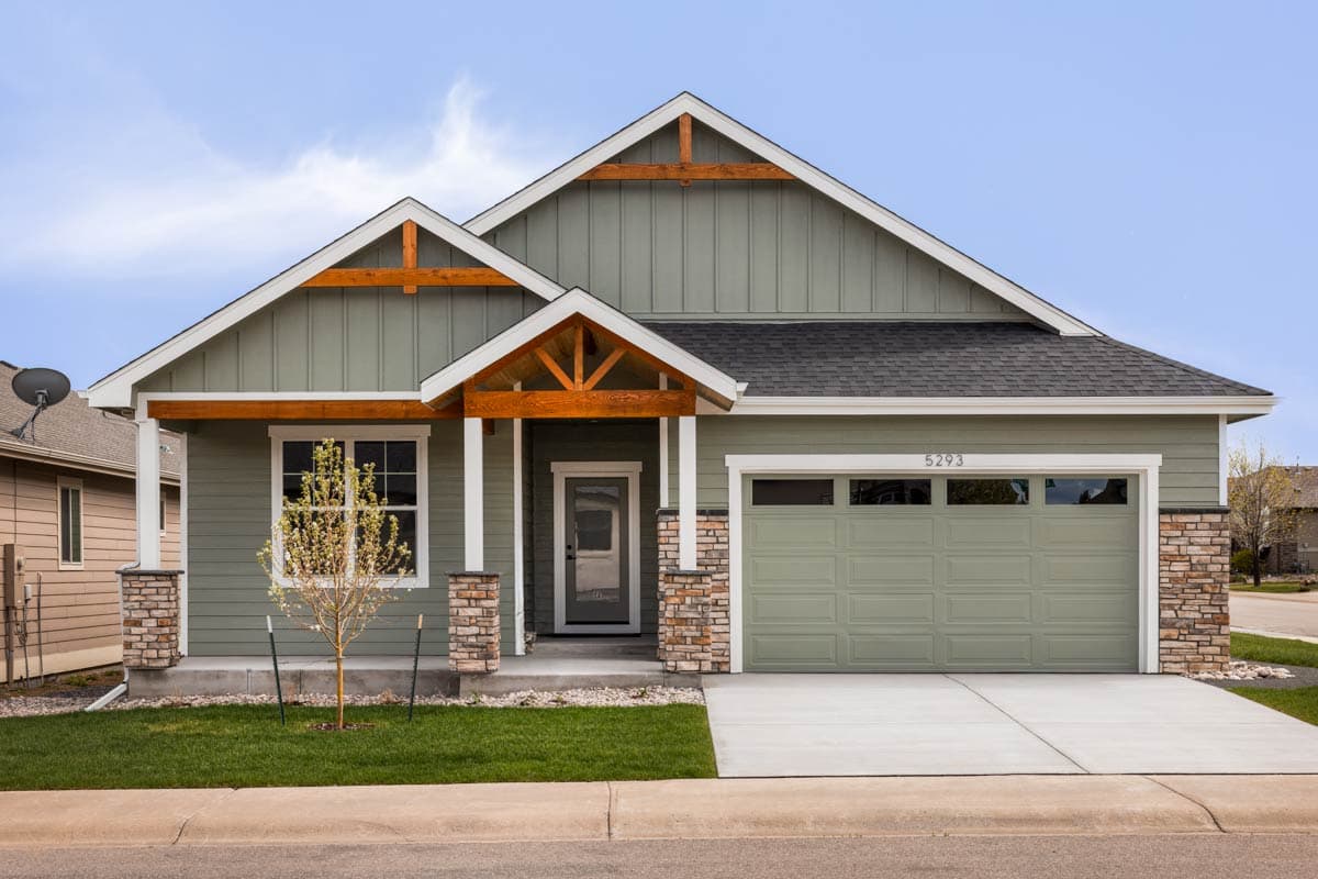 House plan exterior featuring a one-story, Craftsman-style home with gabled rooflines, decorative timber brackets, and a two-car garage.