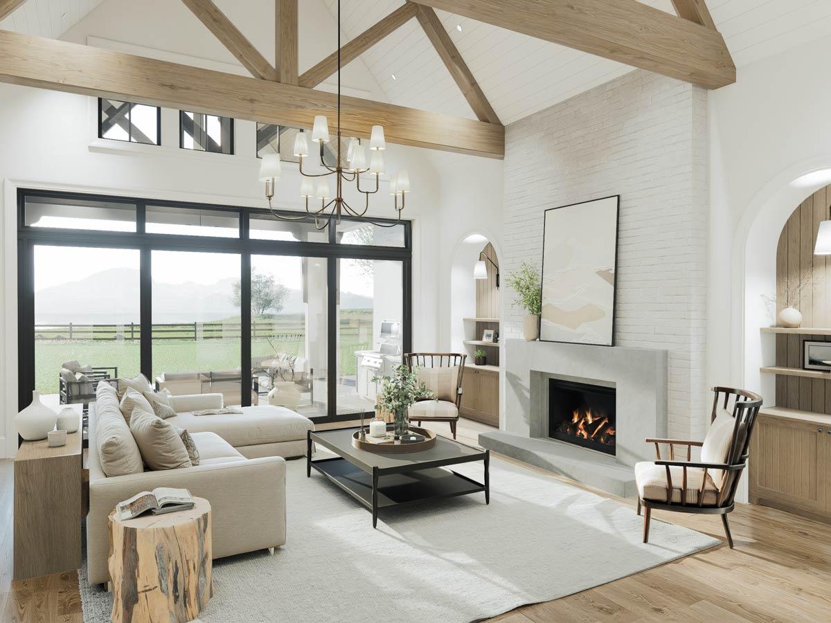 Great room with vaulted wood-beamed ceiling, fireplace, and large windows overlooking outdoor patio.