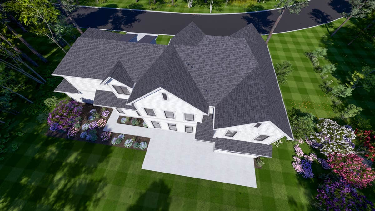 Aerial view of a white house with a dark gray roof. Landscaped garden in front, lush green lawn surrounding. 