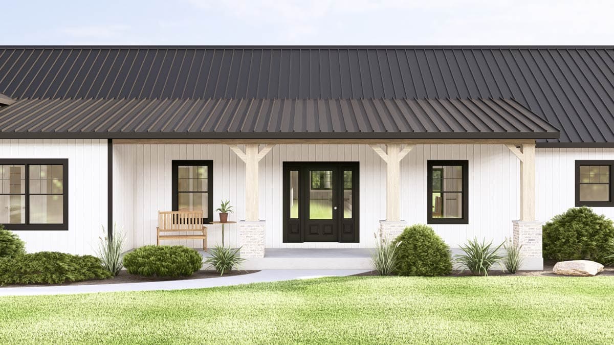 Exterior view of a modern farmhouse with a black metal roof, white siding, and black trim.  Features a front porch and lawn.