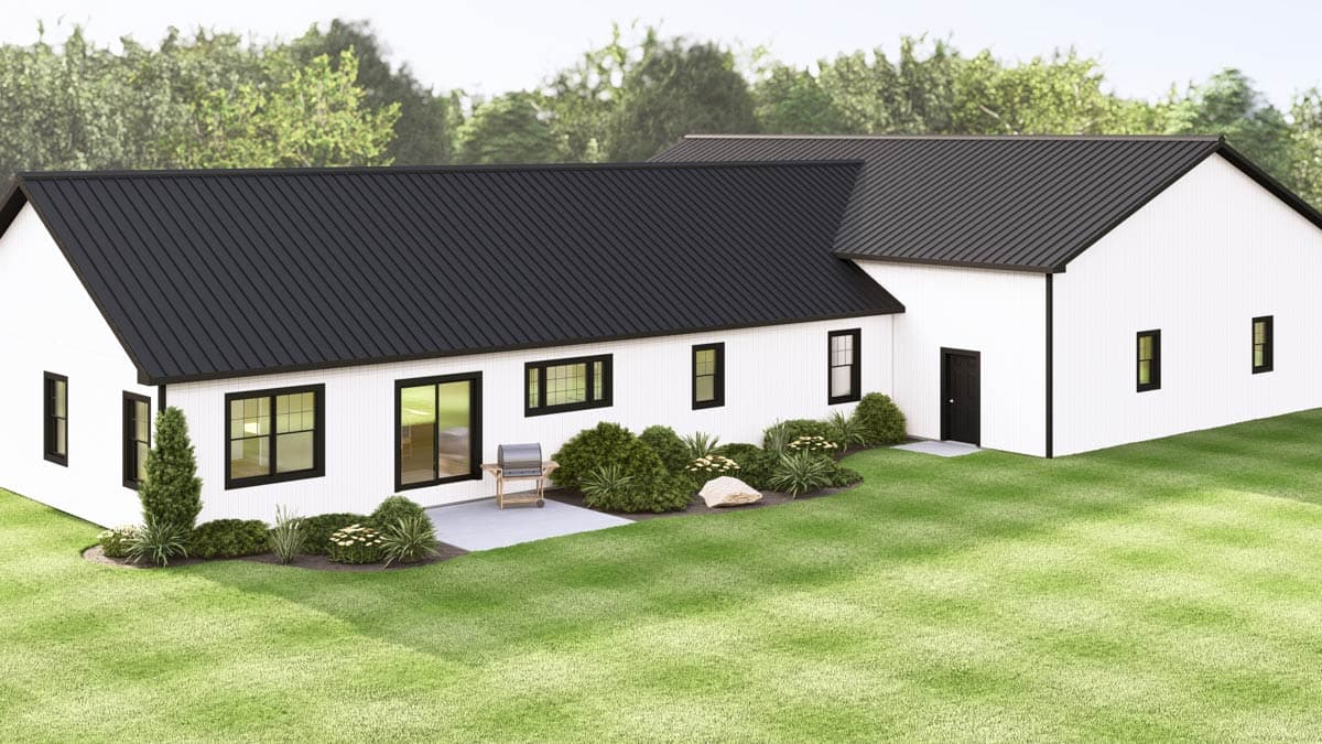 Modern white house with a black metal roof, black trim and windows, and a manicured lawn.