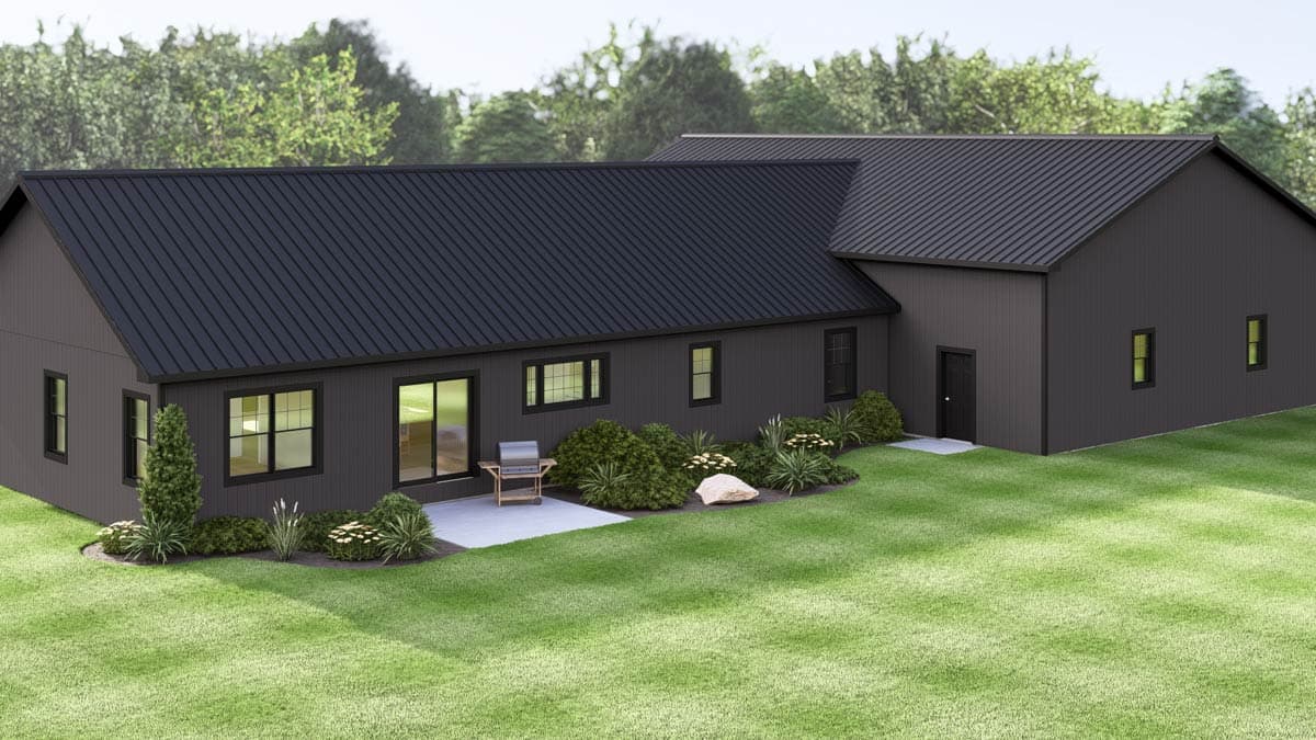 Modern, dark gray house with a black metal roof, patio, and landscaped yard. Green grass surrounds the house.