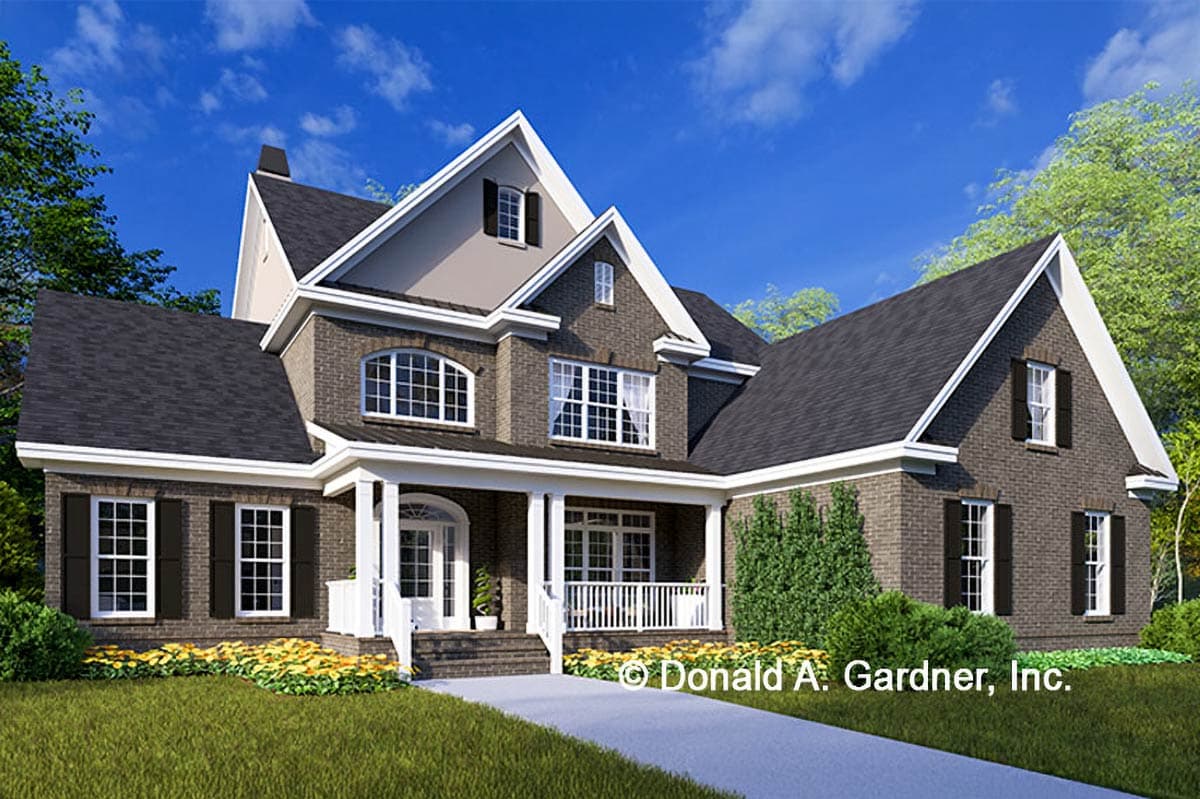 House plan exterior with two stories. Features include a front porch, gables, dormers, and brick exterior.
