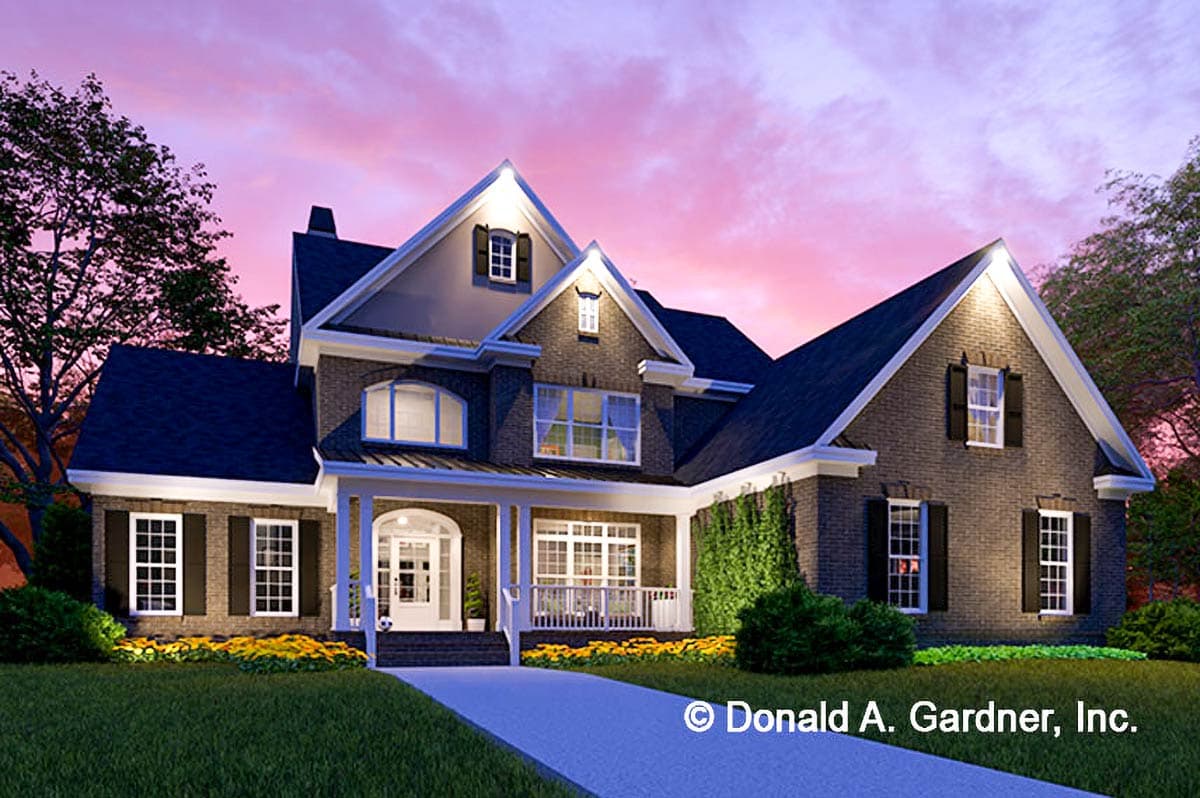 House plan exterior with brick facade, gabled dormers, arched windows, and covered front porch.