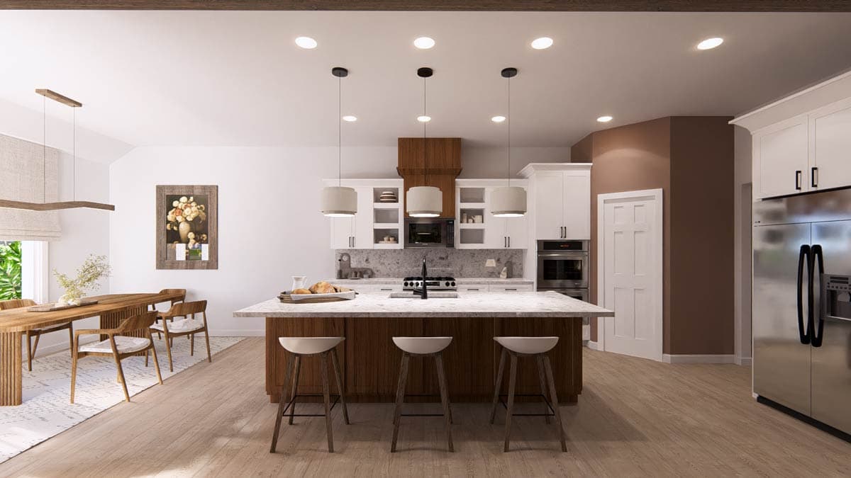 Modern kitchen with island, white cabinets, stainless steel appliances, and adjoining dining area with wooden table.