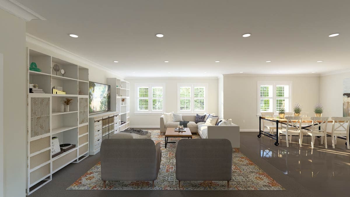 Open concept living and dining area with sectional sofa, built-in shelving, and dining table with chairs.