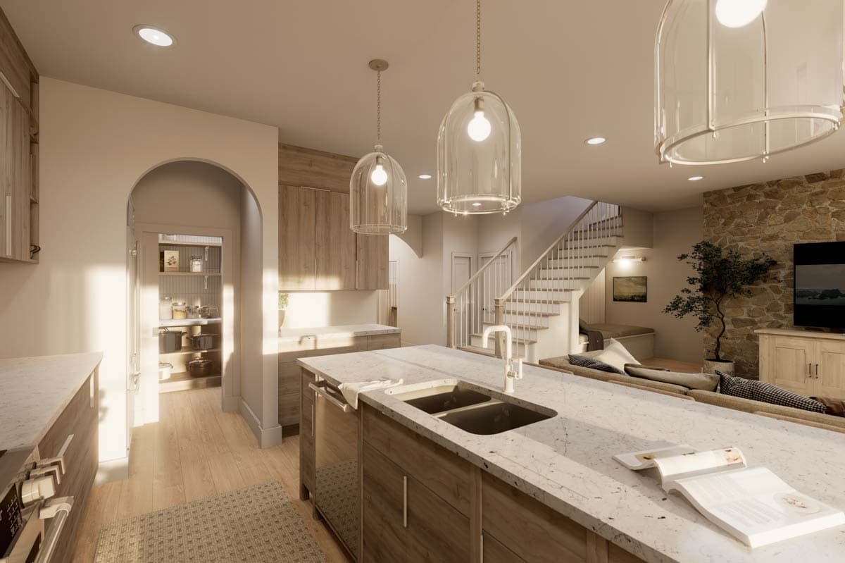 Kitchen with island, pantry, and staircase leading to upper level.