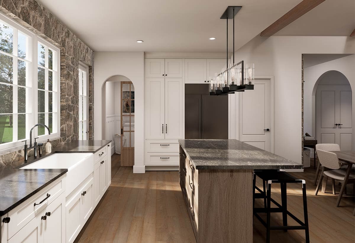 Spacious, modern kitchen with a stone accent wall, white cabinets, and a large island featuring a black countertop and two black stools.